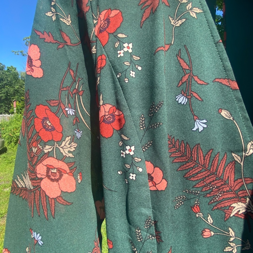 A beautiful wrap dress with sheer sleeves and a slit down the back